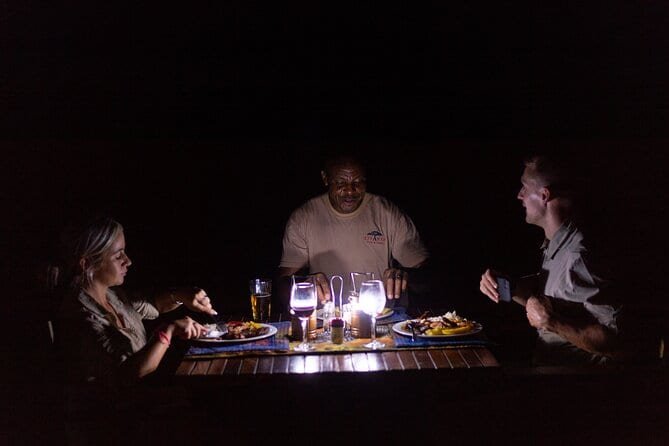 Guests enjoying dinner outdoors after stargazing near Victoria Falls