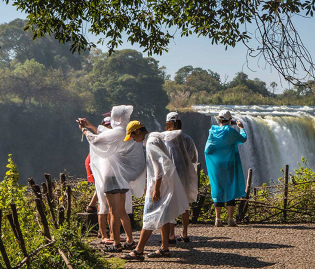 tourists taking in victoria falls waterfalls