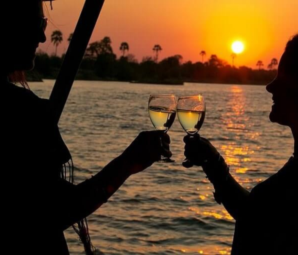 couple toasting to a exceptional victoria falls stay on a sunset cruise